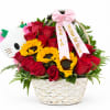 Basket arrangement of red roses and sunflowers with a pink ribbon and plush cat