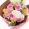 Bouquet of pink gerbera daisies, white hydrangea, and yellow roses