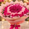 Pink bouquet of roses and ribbon flowers wrapped in pale pink paper