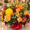 Basket arrangement of yellow and orange roses with mixed chrysanthemums and lilies