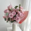 Pink rose bouquet wrapped in white and pink paper