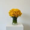 Yellow chrysanthemum bouquet in a clear glass vase