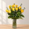 Yellow roses arranged in a clear glass vase