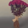 Bouquet of red roses tied with a burlap ribbon