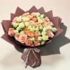 Bouquet of peach and pale pink roses wrapped in mauve paper