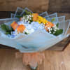 blue hydrangeas, orange roses, yellow gerberas fillers and greens