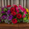 Large mixed bouquet with red gerberas, pink roses, purple flowers, and yellow sunflowers