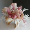 A petite dried corsage in soft pink and white that feels like