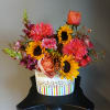 Mixed bouquet with sunflowers, roses, and bright pink blooms in a white box