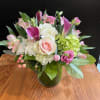 Pink and white mixed flower arrangement in a glass vase