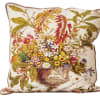 Decorative floral-print throw pillow with a vase of flowers