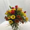 A beautiful mix of fresh Autumn blooms handcrafted and designed in a