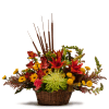 Mixed autumn flower arrangement in a wicker basket with tall brown reeds