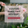 Hand-tied bouquet of pink flowers on a wooden table