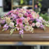 Casket spray of pink and lavender flowers