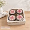 Gift box with four scented candle jars in a wooden crate