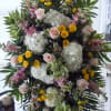 Large standing floral spray with pink roses, white hydrangeas, and yellow blooms