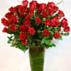 Bouquet of red roses in a tall clear glass vase