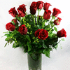 Red roses arranged in a clear glass vase