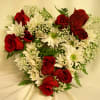 Heart-shaped bouquet of red roses and white daisies