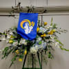 Large floral standing spray with blue banner and yellow-white flowers