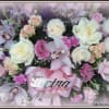 Pink and white floral arrangement with a pink ribbon and "Loving Mom" sign