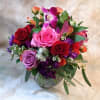 Mixed bouquet of roses and orchids in a glass vase