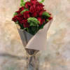 Bouquet of red roses wrapped in gray paper