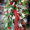 Large standing floral spray with red and white flowers on an easel