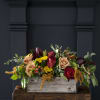Mixed roses in a rustic wooden box with greenery and yellow filler flowers