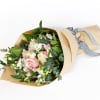 Bouquet of pink and white roses wrapped in kraft paper