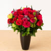 A sultry combination of red and hot pink roses highlighted by lavender