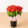 Playful red tulips designed in a sleek black glass vase accented by