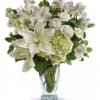 White lilies and alstroemeria in a clear glass vase