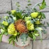 Yellow-green floral arrangement in a patterned ceramic pot