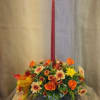 Autumn floral centerpiece with a tall red taper candle