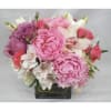 Pink and white bouquet in a square glass vase