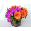 Orange dahlias and purple orchids in a glass vase