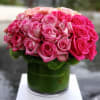 Pink and blush roses arranged in a glass vase