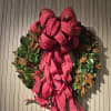 Decorative wreath with a large red ribbon bow