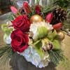 Red roses and green orchids with pinecones and gold ornaments
