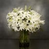 The design features white Casablanca lillies in a vase AS SHOWN PREMIUM