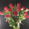 Red roses arranged in a clear glass vase