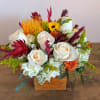 A wooden box or a white ceramic vase with white hydrangea, roses