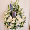 White and blue floral arrangement in a metallic vase