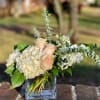 Blush roses and white hydrangeas in a clear glass vase