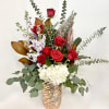 Red roses and white hydrangea in a metallic vase