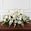 Large white casket spray of lilies, roses and clustered blooms with clear
