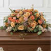 Large, low peach and pink rose spray with carnations and soft foliage