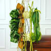 Tall, ceremonial easel arrangement with white roses, green foliage, orange accents and